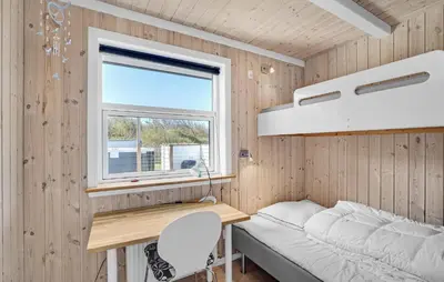 a bedroom with a desk and a bed and a window at Stunning Home In Vestervig With Sauna in Vestervig