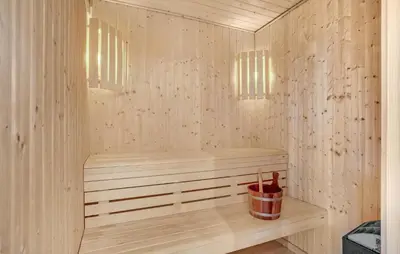 a wooden sauna with a bench and two lights at Stunning Home In Vestervig With Sauna in Vestervig