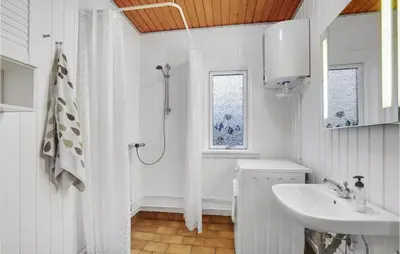 a white bathroom with a shower and a sink at Gorgeous Home In Harboøre With Wifi in Harboør