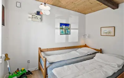 a bedroom with a bed and a toy truck in it at Cozy Home In Nykøbing M With Kitchen in Tæbring