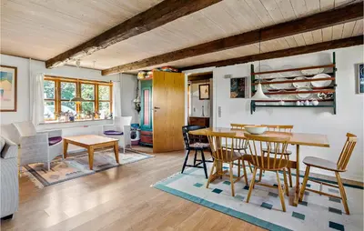 a kitchen and dining room with a table and chairs at Cozy Home In Nykøbing M With Kitchen in Tæbring