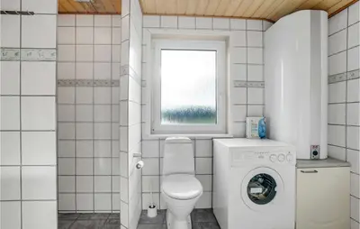 a small bathroom with a toilet and a window at Awesome Home In Lemvig With Wifi in Lemvig