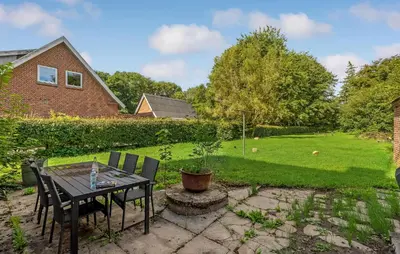 a patio with a table and chairs in a yard at 3 Bedroom Nice Home In Fur in Fur