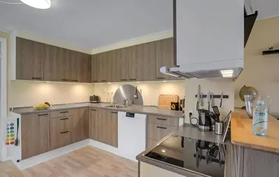 a kitchen with wooden cabinets and a stove top oven at 3 Bedroom Nice Home In Fur in Fur