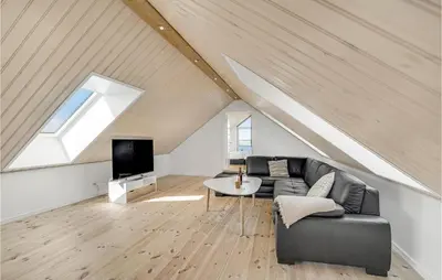 a living room with a couch and a tv at Stunning Home In Harboøre With Sauna in Harboør