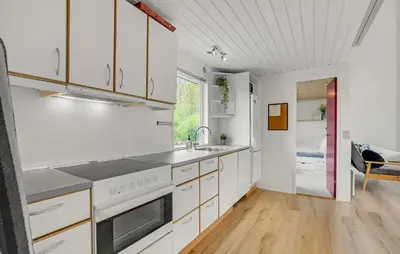 a kitchen with white cabinets and a sink at Nice Home In Roslev With Kitchen in Roslev