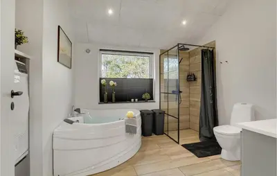 a bathroom with a tub and a shower and a toilet at Nice Home In Hurup Thy With Wifi in Sindrup