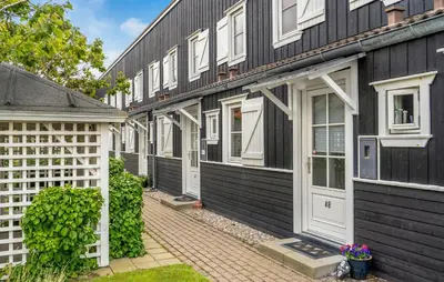a row of black houses with white doors at Awesome Apartment In Vestervig in Vestervig