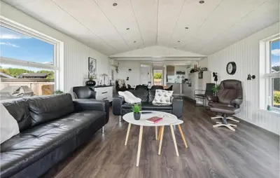 a living room with a couch and a table at 3 Bedroom Nice Home In Hurup Thy in Doverodde
