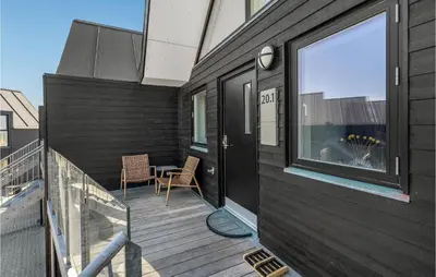 a black house with a balcony with a table at Stunning Apartment In Thisted With Wifi in Thisted