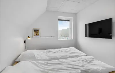 a white bedroom with a bed and a flat screen tv at Stunning Apartment In Thisted With Wifi in Thisted
