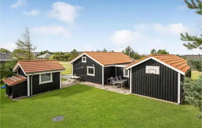 a group of three cottages in a yard at Stunning Home In Løgstør With Wifi in Løgstør