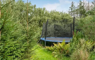 an empty trampoline in the middle of the forest at Stunning Home In Løgstør With Wifi in Løgstør