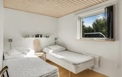 a room with two beds and a window at Stunning Home In Løgstør With Wifi in Løgstør