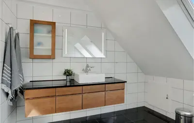 a bathroom with a sink and a mirror at Lovely Home In Aabybro With Kitchen in Åbybro