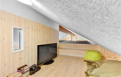 a living room with a television and a couch at Stunning Home In Spøttrup With Sauna in Spottrup