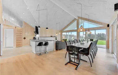 a dining room and kitchen with a table and chairs at Stunning Home In Spøttrup With Sauna in Spottrup
