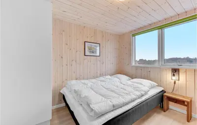 a bedroom with a bed in a room with a window at Stunning Home In Spøttrup With Sauna in Spottrup