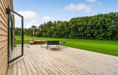 a patio with a table and chairs on a wooden deck at Amazing Home In Spøttrup With Wifi in Spottrup
