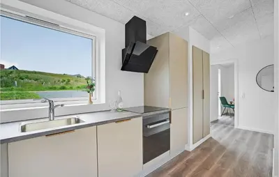 a kitchen with a sink and a large window at Amazing Home In Spøttrup With Wifi in Spottrup