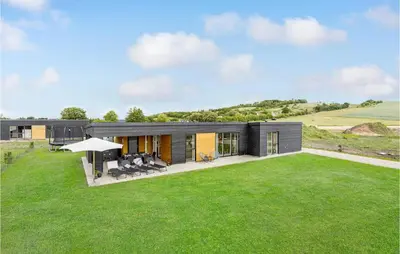 a modern house with a green lawn at Gorgeous Home In Løgstrup With Kitchen in Løgstrup