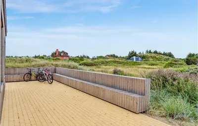 two bikes parked on a fence on a boardwalk at 3 Bedroom Lovely Home In Fjerritslev in Fjerritslev