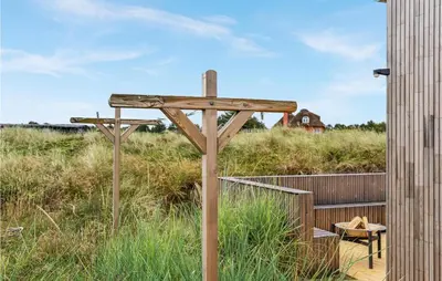 a wooden cross in the middle of a field at 3 Bedroom Lovely Home In Fjerritslev in Fjerritslev