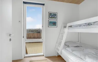 a white bedroom with a bunk bed and a window at 3 Bedroom Lovely Home In Fjerritslev in Fjerritslev
