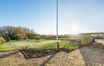 a field of grass with a pole in the middle at Lovely Home In Hurup Thy With Wifi in Gettrup
