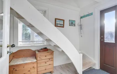 a white staircase in a room with a wooden dresser at Nice Home In Bedsted Thy in Bedsted Thy