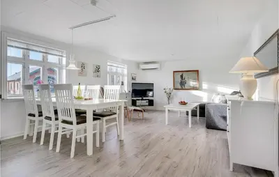 a living room with a white table and chairs at Nice Home In Bedsted Thy in Bedsted Thy