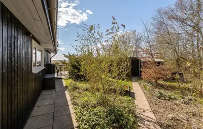 a house with a sidewalk next to a building at Awesome Home In Roslev With Kitchen in Roslev