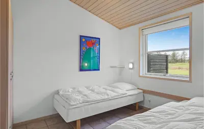 a bedroom with two beds and a window at Beautiful Home In Pandrup With Wifi in Pandrup