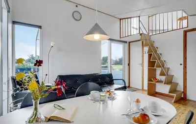 a living room with a table with a vase of flowers at 1 Bedroom Gorgeous Home In Vestervig in Vestervig