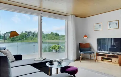a living room with a large sliding glass door at 2 Bedroom Awesome Home In Vemb in Vemb