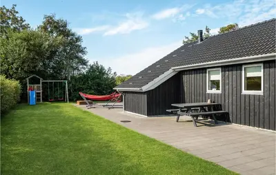 a black building with a picnic table and a playground at Gorgeous Home In Vemb in Vemb