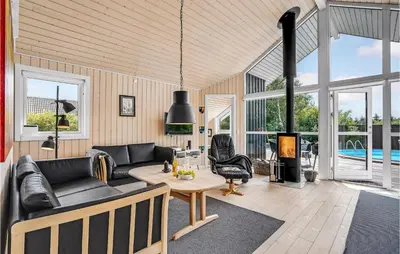 a living room with a couch and a fireplace at Gorgeous Home In Vemb in Vemb