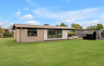 a house with a large lawn in front of it at 3 Bedroom Lovely Home In Spøttrup in Spottrup