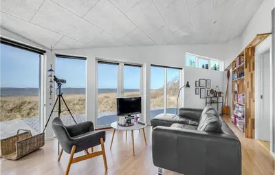 a living room with a couch and chairs and windows at Stunning Home In Højslev With Kitchen in Højslev