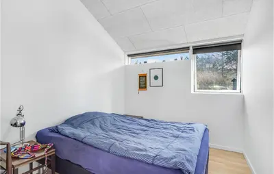 a bedroom with a bed and a window at Stunning Home In Højslev With Kitchen in Højslev