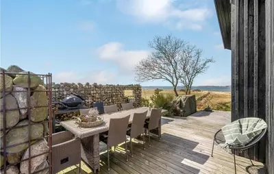 a patio with a table and chairs on a deck at Stunning Home In Højslev With Kitchen in Højslev