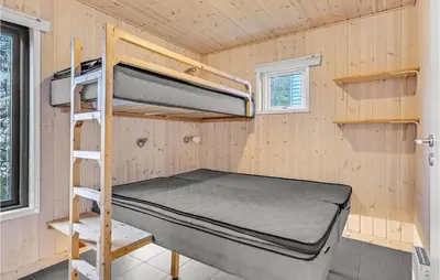 a tiny house with a bunk bed and a ladder at Stunning Home In Hanstholm in Hanstholm