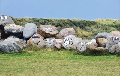 a bunch of rocks with faces painted on them at Cozy Home In Harboøre With Sauna in Harboør