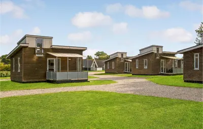 a row of houses in a yard with grass at Gorgeous Home In Vestervig With Kitchen in Vestervig
