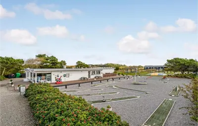 a park with a building and a playground at Gorgeous Home In Vestervig With Kitchen in Vestervig