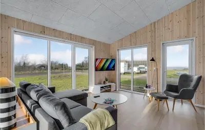 a living room with a couch and chairs and windows at Beautiful Home In Løgstrup With Kitchen in Løgstrup