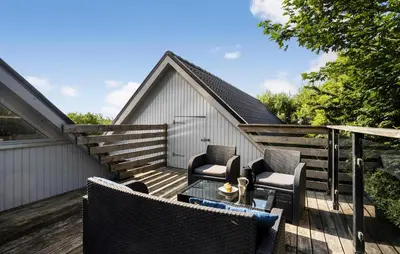 a patio with two chairs and a table on a deck at Pet Friendly Home In Vils With Sauna in Vils