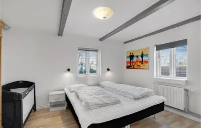 a white bedroom with a bed and two windows at Pet Friendly Home In Vils With Sauna in Vils