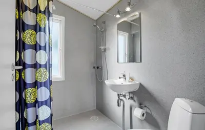 a bathroom with a sink and a toilet and a mirror at Cozy Home In Vestervig With Wifi in Vestervig