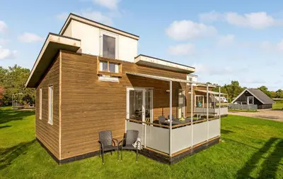 a tiny house on the grass with two chairs at Cozy Home In Vestervig With Wifi in Vestervig